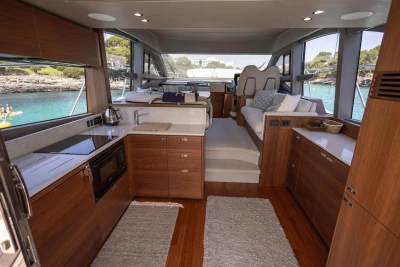 Luxurious interior of 2024 Princess F50 yacht with modern kitchen and scenic ocean view.
