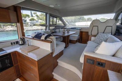 Luxurious interior of 2024 Princess F50 yacht with modern kitchen and seating area.
