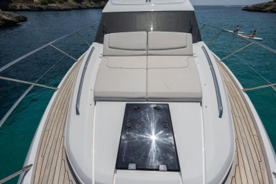 Luxurious 2024 Princess F50 yacht with sunbathing deck, cruising in clear blue waters.