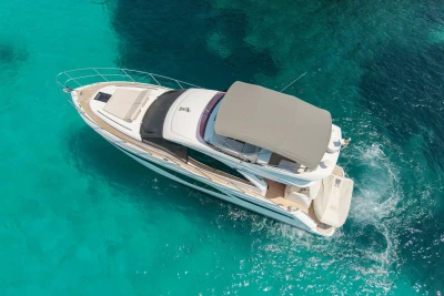 Aerial view of 2024 Princess F50 yacht cruising in clear turquoise waters.