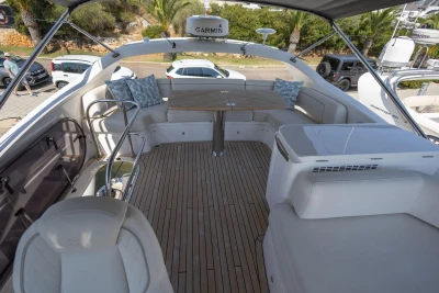 Luxurious 2024 Princess F50 yacht deck with seating, table, and Garmin navigation system.
