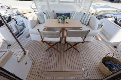 Luxurious 2024 Princess F50 yacht deck with elegant seating and wooden table.