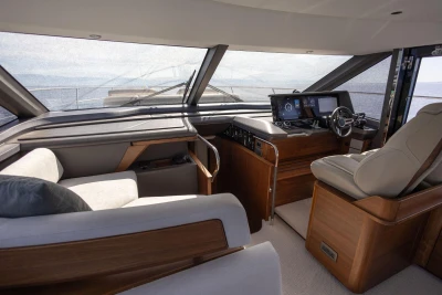 Luxurious 2025 Princess F65 yacht interior with modern helm and comfortable seating.
