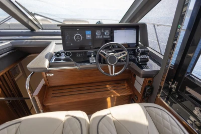 Luxurious helm of 2025 Princess F65 yacht with advanced navigation controls and leather seating.