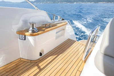 Luxurious 2025 Princess F65 yacht deck with teak flooring, cruising on open sea.