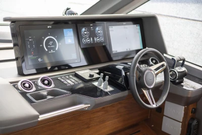 Modern helm of 2025 Princess F65 yacht with advanced navigation displays and controls.