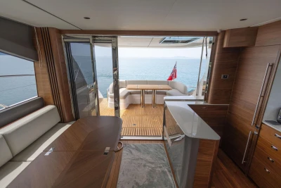Luxurious interior of 2025 Princess F65 yacht with ocean view and elegant wood finishes.