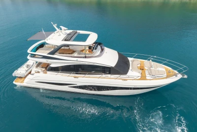Luxurious 2025 Princess F65 yacht cruising on clear blue waters.