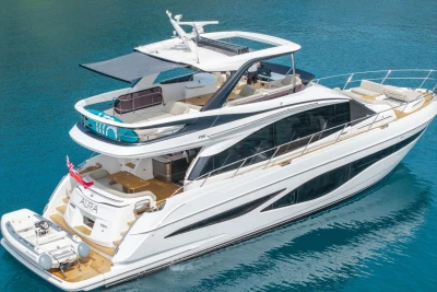 Luxurious 2025 Princess F65 yacht on clear blue water, showcasing sleek design and spacious decks.