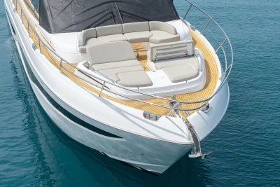 Luxury 2025 Princess F65 yacht with elegant deck and seating on calm blue water.