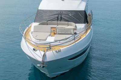 Luxury 2025 Princess F65 yacht with spacious deck and elegant seating on calm water.