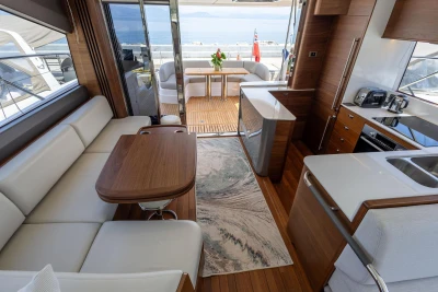 Luxurious interior of 2025 Princess F65 yacht with modern kitchen and seating area.