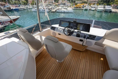 Luxurious 2025 Princess F65 yacht cockpit with modern controls and elegant seating.