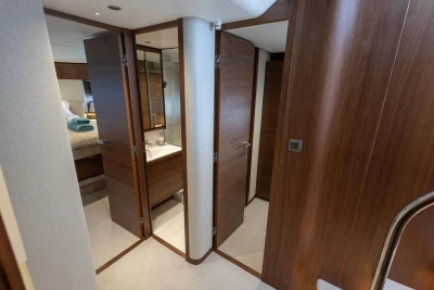 Luxurious interior of 2025 Princess F65 yacht featuring wood paneling and modern design.