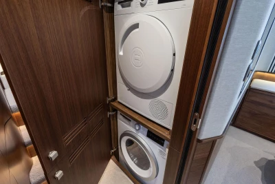 Stacked washer and dryer in 2025 Princess F65 yacht interior.