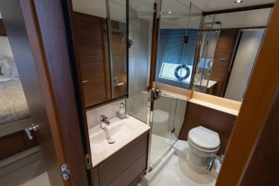 Luxurious bathroom in 2025 Princess F65 yacht, featuring modern fixtures and elegant wood finishes.