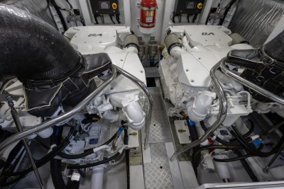 Engine room of 2025 Princess F65 yacht with dual engines and fire extinguisher.
