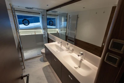 Luxurious bathroom on 2026 Princess Y72 yacht, featuring dual sinks and modern fixtures.