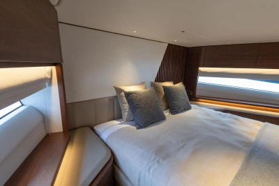 Luxurious bedroom interior of 2026 Princess Y72 yacht with elegant design and cozy bedding.
