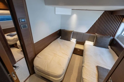 Luxurious twin cabin interior on 2026 Princess Y72 yacht, featuring modern design and cozy bedding.