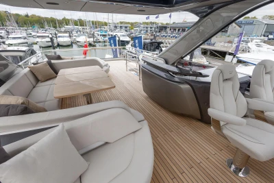 Luxurious 2026 Princess Y72 yacht deck with elegant seating and marina view.