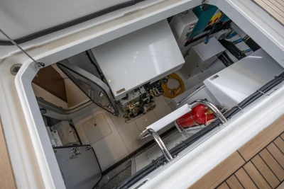 Engine room of 2026 Princess Y72 yacht, featuring equipment and fire extinguisher.