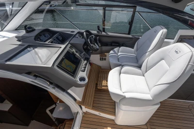 Luxury helm of 2026 Princess V40 yacht with modern navigation controls and plush seating.