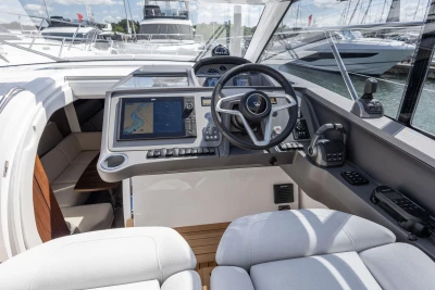 Interior view of 2026 Princess V40 yacht cockpit with modern navigation system and steering wheel.