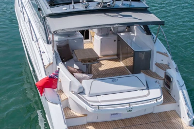 2026 Princess V40 yacht with elegant deck, seating, and flag on calm water.