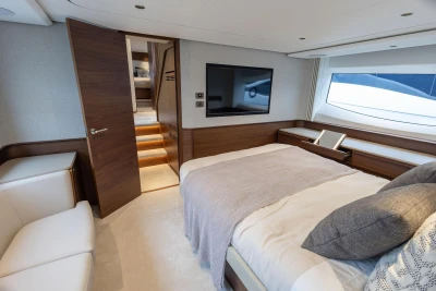 Luxurious bedroom interior of 2026 Princess F65 yacht with modern design and large window.