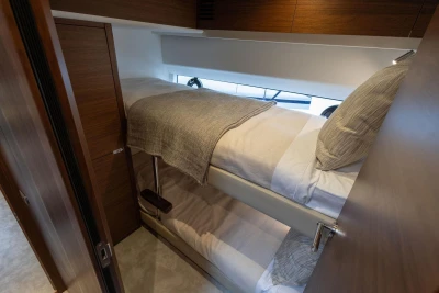 Bunk beds in the 2026 Princess F65 yacht cabin, featuring modern wood finishes.