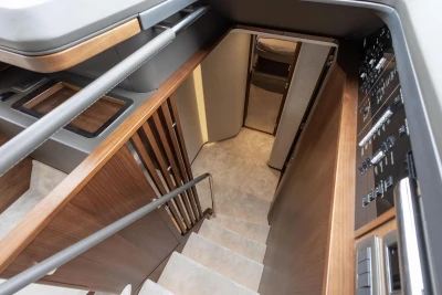 Interior staircase of 2026 Princess F65 yacht, featuring modern design and control panel.