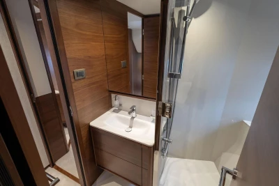 Luxurious bathroom in 2026 Princess F65 yacht with modern wood finishes and sleek fixtures.
