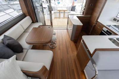 Luxurious interior of 2026 Princess F65 yacht with modern wood finishes and elegant seating.