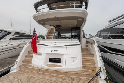 2026 Princess F65 yacht docked, showcasing elegant design and spacious deck area.