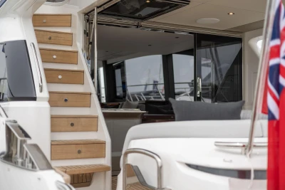 Luxury Princess F65 yacht interior with wooden stairs and elegant seating, 2026 model.