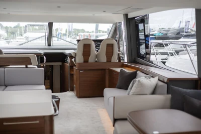 Luxurious interior of 2026 Princess F65 yacht with modern seating and helm station.