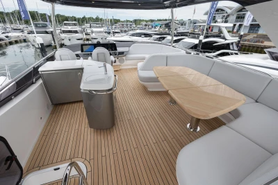 Luxurious 2026 Princess F65 yacht interior with sleek seating and elegant wooden table.