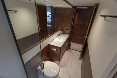 Luxurious bathroom interior of 2026 Princess F65 yacht with modern fixtures and wood accents.