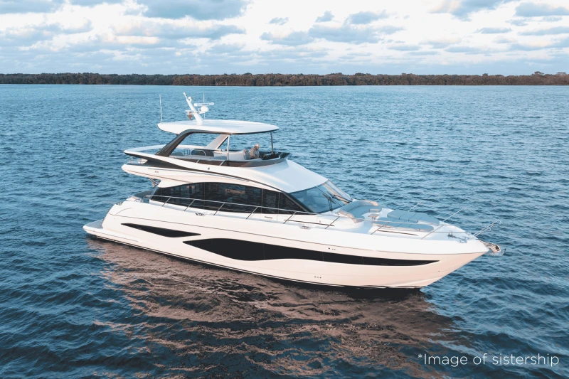 2026 Princess F65 yacht cruising on serene blue waters under a partly cloudy sky.