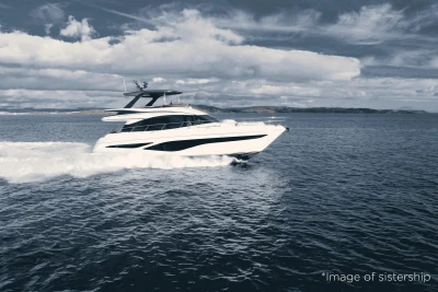 Luxury Princess F65 yacht cruising on open sea under cloudy sky, 2026 model.