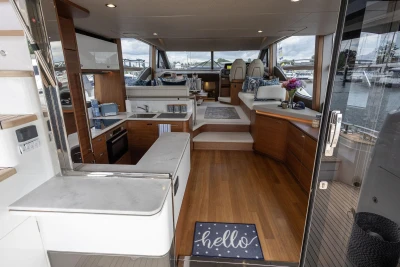 Luxurious interior of 2020 Princess F55 yacht with modern kitchen and cozy seating area.