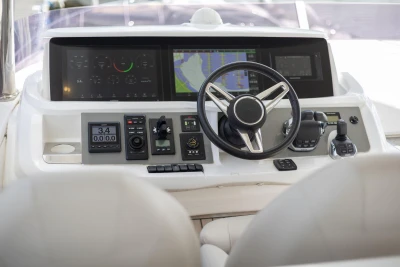 Cockpit of 2020 Princess F55 yacht with modern navigation controls and steering wheel.