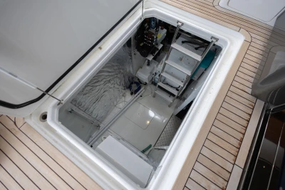 Engine room access hatch on 2020 Princess F55 yacht, featuring ladder and equipment.
