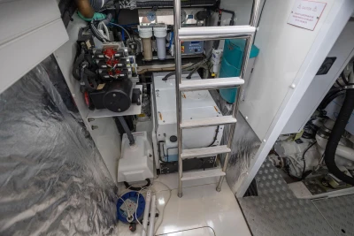 Engine room of 2020 Princess F55 yacht with equipment and ladder.