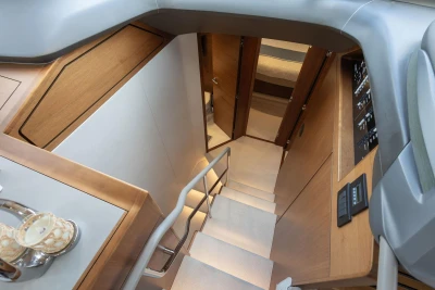 Interior view of 2020 Princess F55 yacht, featuring elegant wooden stairs and modern design.