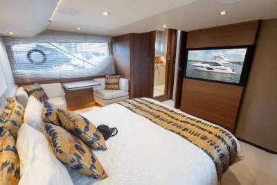 Luxurious 2020 Princess F55 yacht bedroom with elegant decor and large window view.