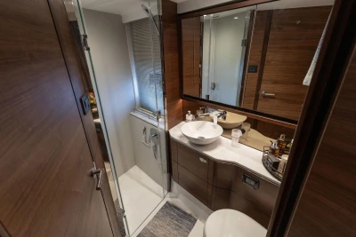 Luxurious bathroom interior of 2020 Princess F55 yacht with modern fixtures and wood accents.