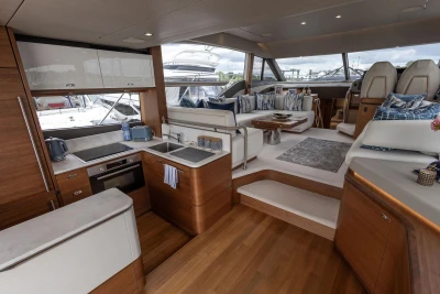 Luxurious interior of 2020 Princess F55 yacht with modern kitchen and elegant seating area.