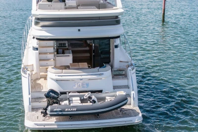 Luxury Princess F55 yacht from 2020 with a small inflatable boat on the deck.